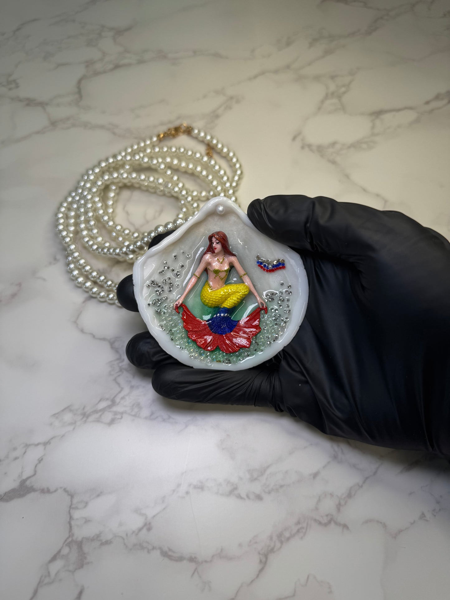 Venezuela Esperanza Siren Natural seashell featuring a miniature mermaid with brown hair and a yellow tail inspired by the Venezuelan flag