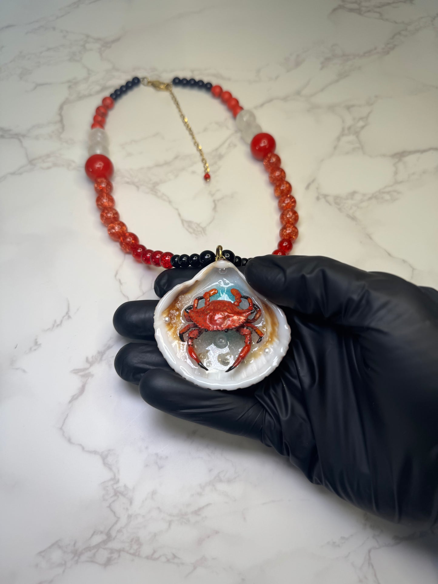 Fire Tide Sentinel Natural seashell featuring a handmade craft metal red-and-black spotted crab. Beautiful semiprecious Stones Necklace