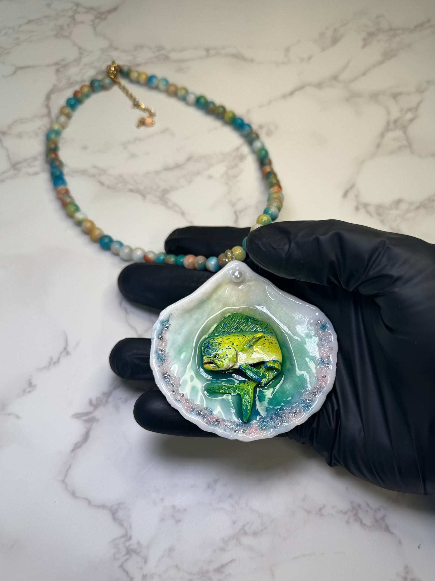 Tropical Horizon Drift Natural seashell featuring a beautiful unique metal handmade yellow-and-green mahi-mahi, glittered sand, and clear gems preserved in clear UV resin Beautiful natural stones necklace