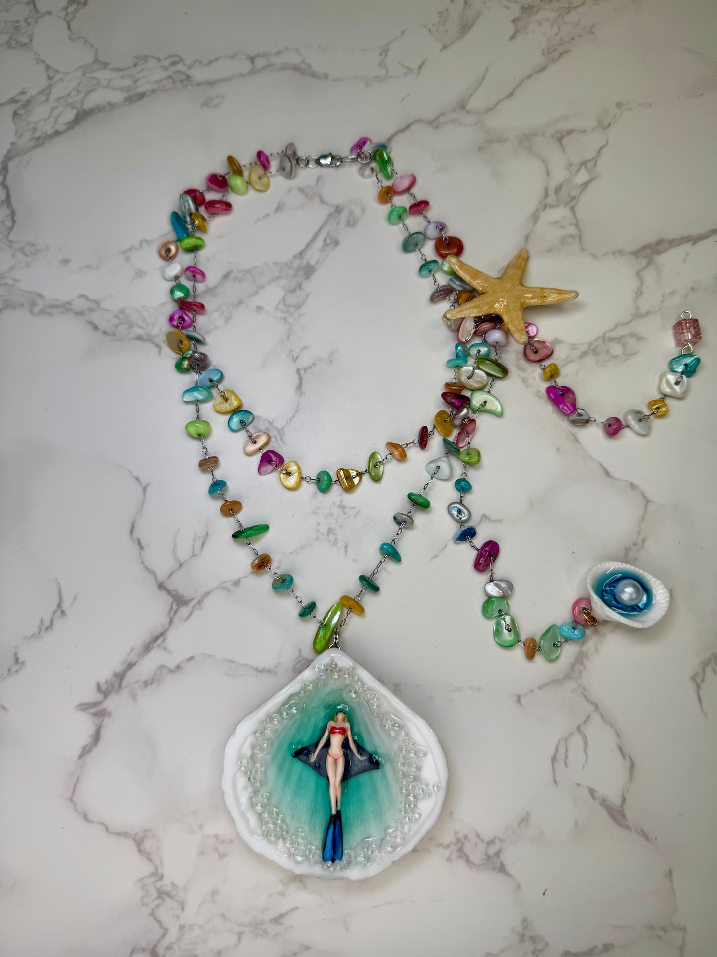 Rainbow Reef Explorer Natural seashell featuring a miniature scuba diver, manta ray, and tiny starfish Silver 925