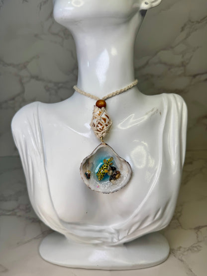 Golden Reef Keeper Natural seashell featuring a miniature yellow-and-black dotted puffer fish, tiny coral bits, and small seashells encapsulated in clear UV resin