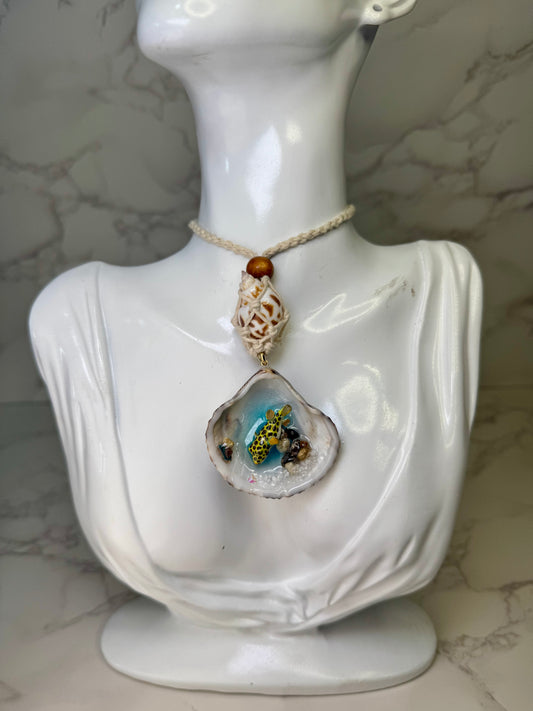Golden Reef Keeper Natural seashell featuring a miniature yellow-and-black dotted puffer fish, tiny coral bits, and small seashells encapsulated in clear UV resin