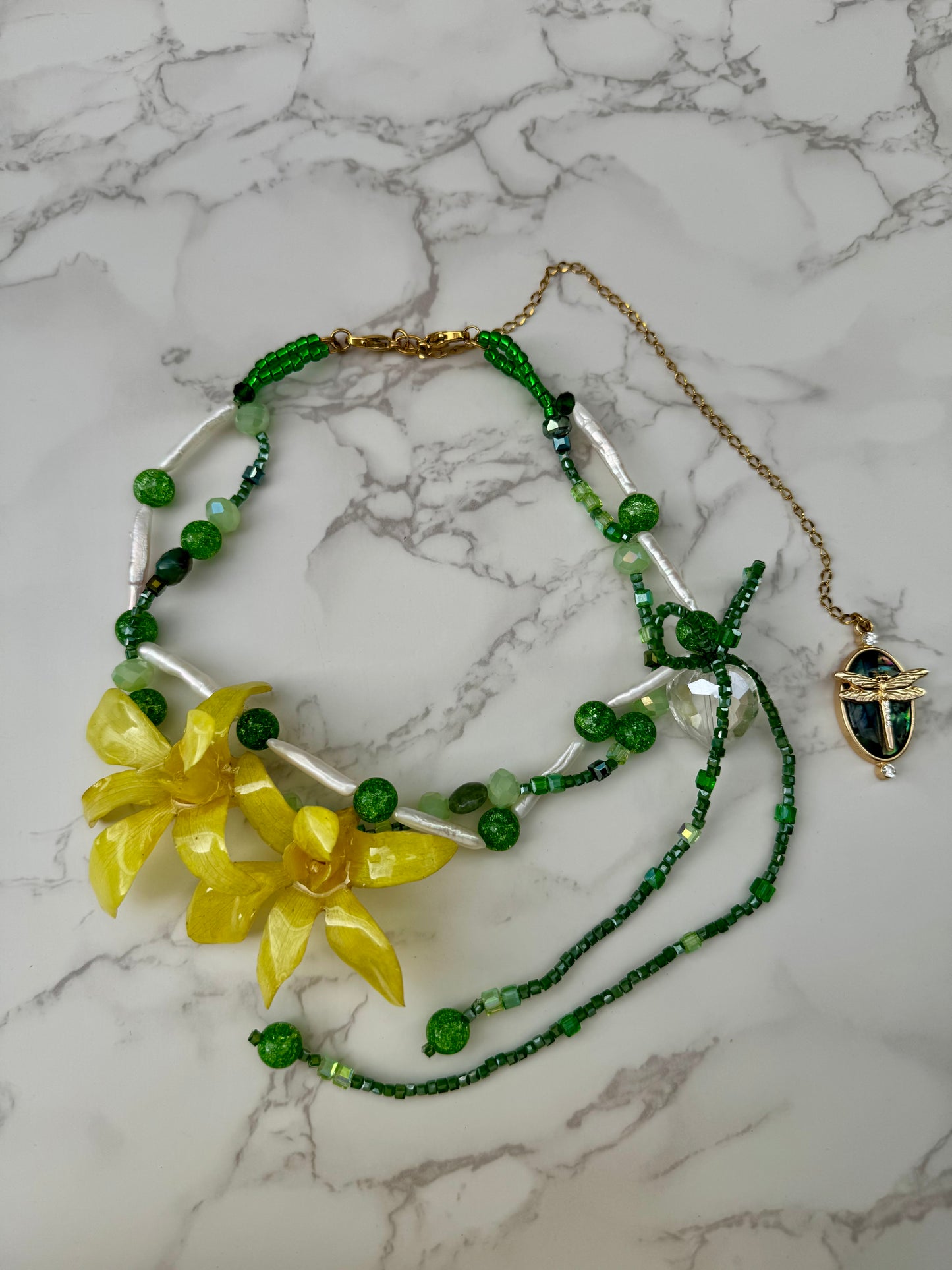 Golden Twin Orchid Grace Two Mini Orchid Orchid Necklace – Green Crystals, Long Pearls, Crystal Heart & Dragonfly on Green Mother-of-Pearl Extension