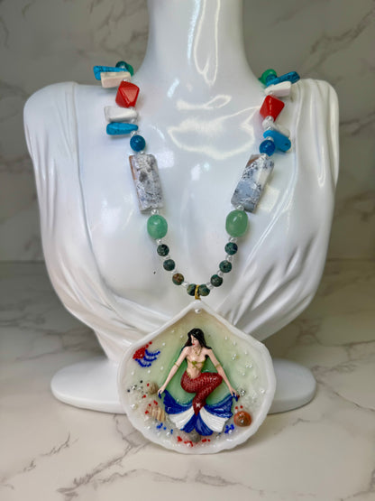 Cuba Libre Mermaid Natural seashell featuring a handmade craft metal mermaid with brown hair and a red tail inspired by the Cuban flag preserved in UV resin Beautiful Stones Necklace Handmade craft jewelry