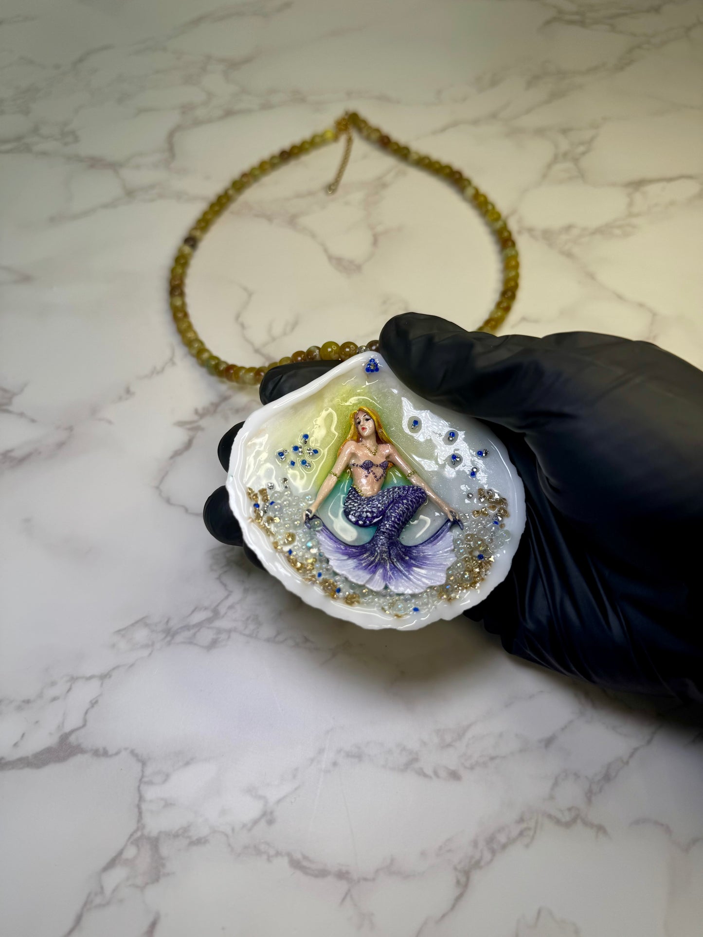 Bluewave Siren Natural seashell featuring a handmade crafted metal mermaid with blonde hair and a shimmering blue tail encapsulated in clear UV resin Beautiful Natural Stones Beads Necklace