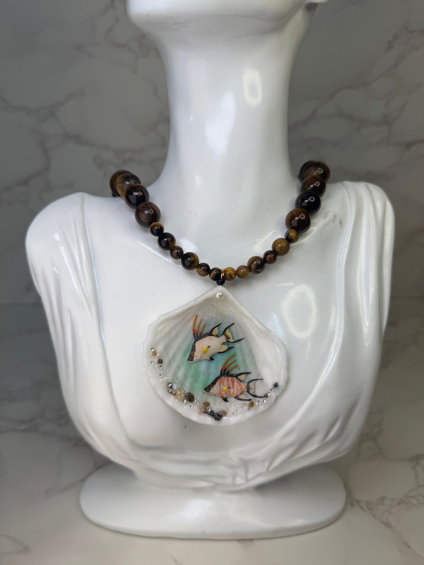 Twin Reef Drifters Natural seashell featuring two miniature hogfish and a brown crystal necklace encapsulated in clear UV resin