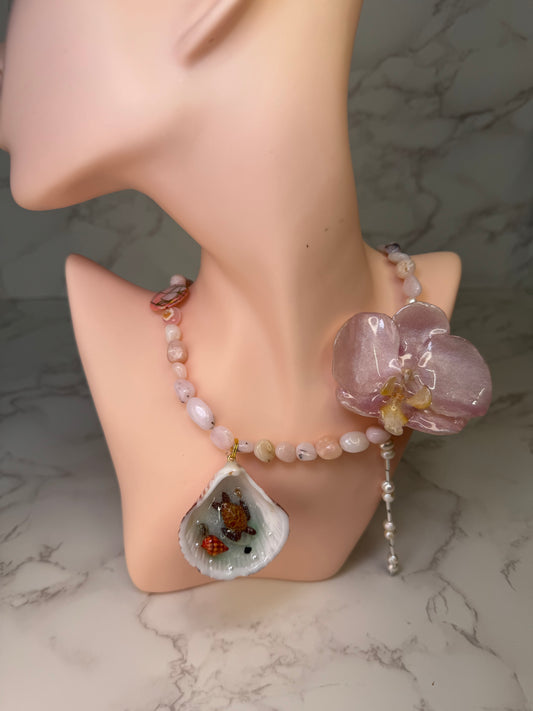 Pink Orchid Blossom Pink orchid flower centerpiece with a pink seashell holding a miniature sea turtle