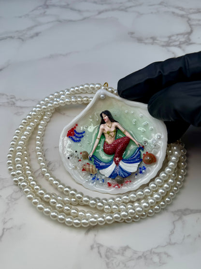 Cuba Libre Mermaid Natural seashell featuring a handmade craft metal mermaid with brown hair and a red tail inspired by the Cuban flag preserved in UV resin Beautiful Stones Necklace Handmade craft jewelry Crystal Pearl Necklace