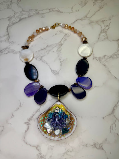 Violet Reef Whisper Natural seashell featuring a handmade metal purple octopus and colorful coral pieces encapsulated in clear UV resin Beautiful combined necklace