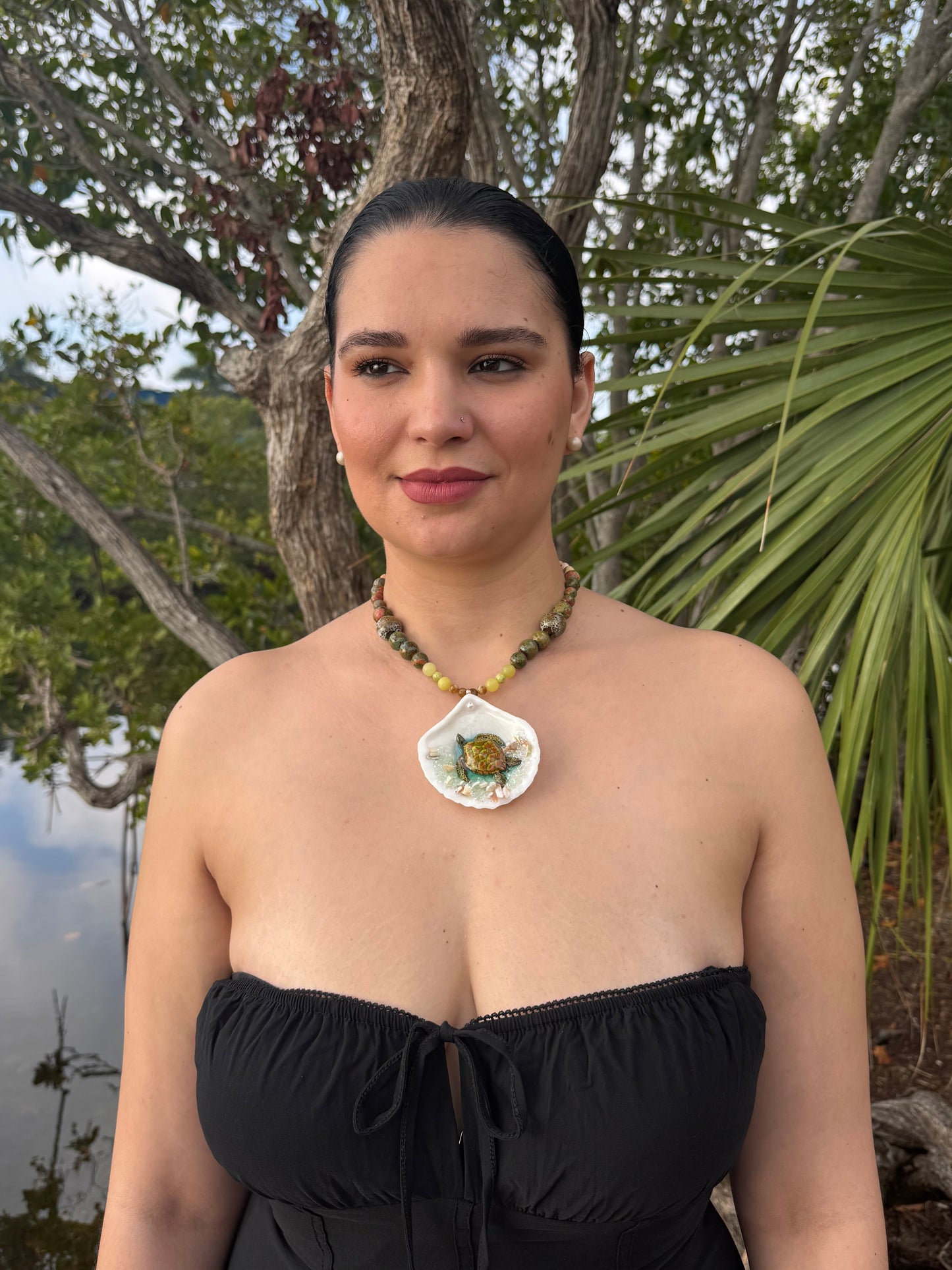 Emerald Tide Guardian Natural seashell featuring a handmade metal green sea turtle, bits of sand, coral, and a green–olive crystal ball necklace encapsulated in clear UV resin Beautiful natural stone’s necklace