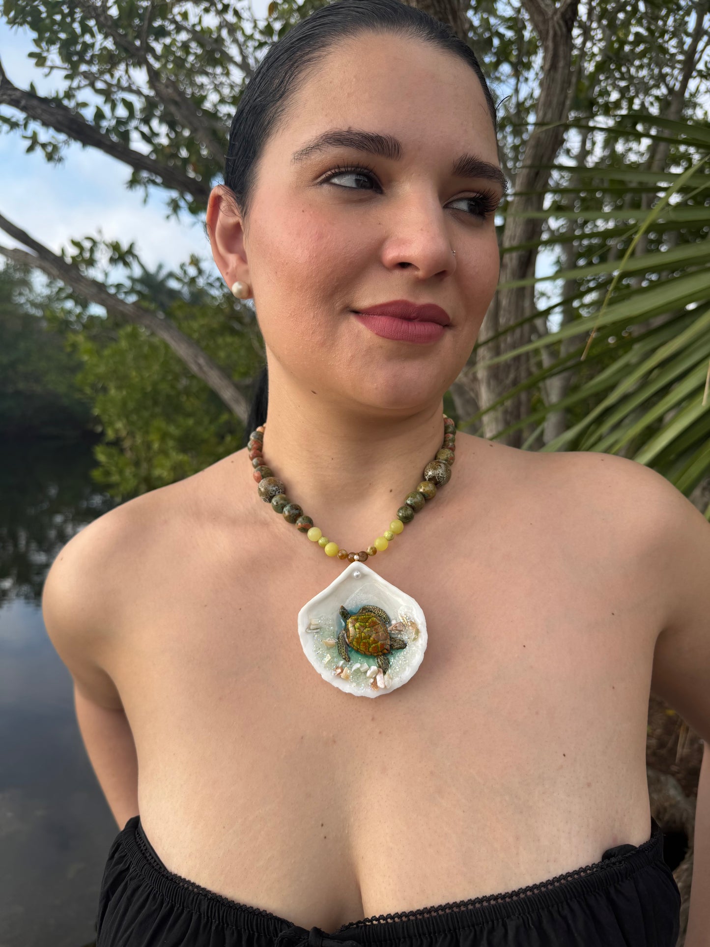 Emerald Tide Guardian Natural seashell featuring a handmade metal green sea turtle, bits of sand, coral, and a green–olive crystal ball necklace encapsulated in clear UV resin Beautiful natural stone’s necklace