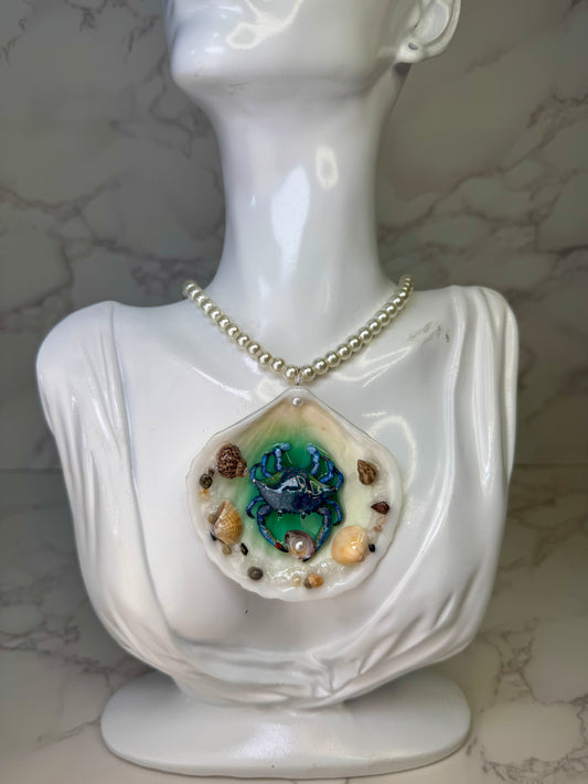 Tidal Blossom Crab Natural seashell featuring a miniature blue-and-pink dotted crab and small seashells encapsulated in clear UV resin