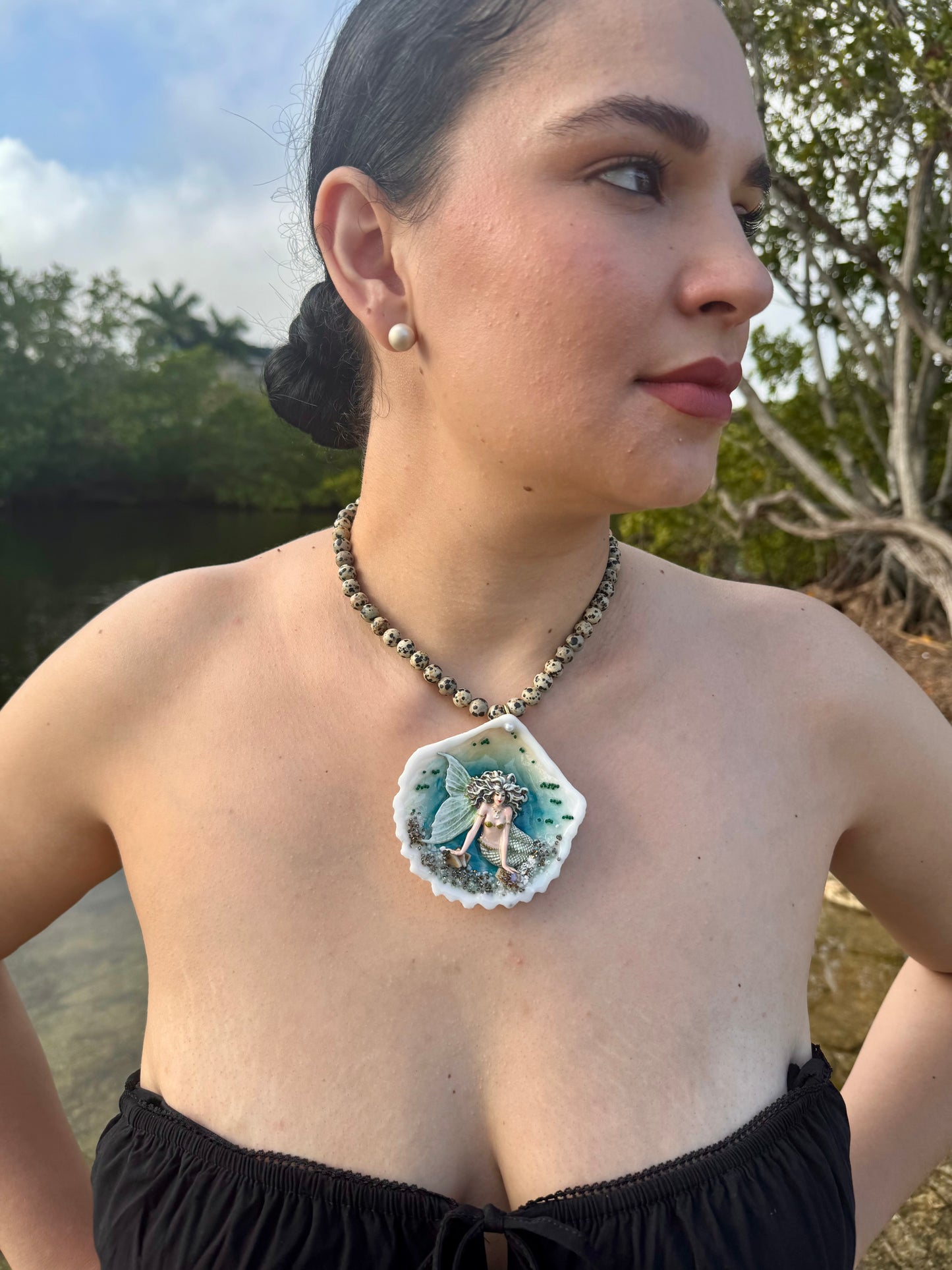 Moonshell Siren Natural seashell featuring a handmade craft metal mermaid with white hair and a pearlescent white tail encapsulated in clear UV resin Beautiful semiprecious stones necklace