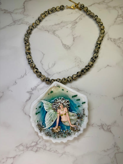 Moonshell Siren Natural seashell featuring a handmade craft metal mermaid with white hair and a pearlescent white tail encapsulated in clear UV resin Beautiful semiprecious stones necklace