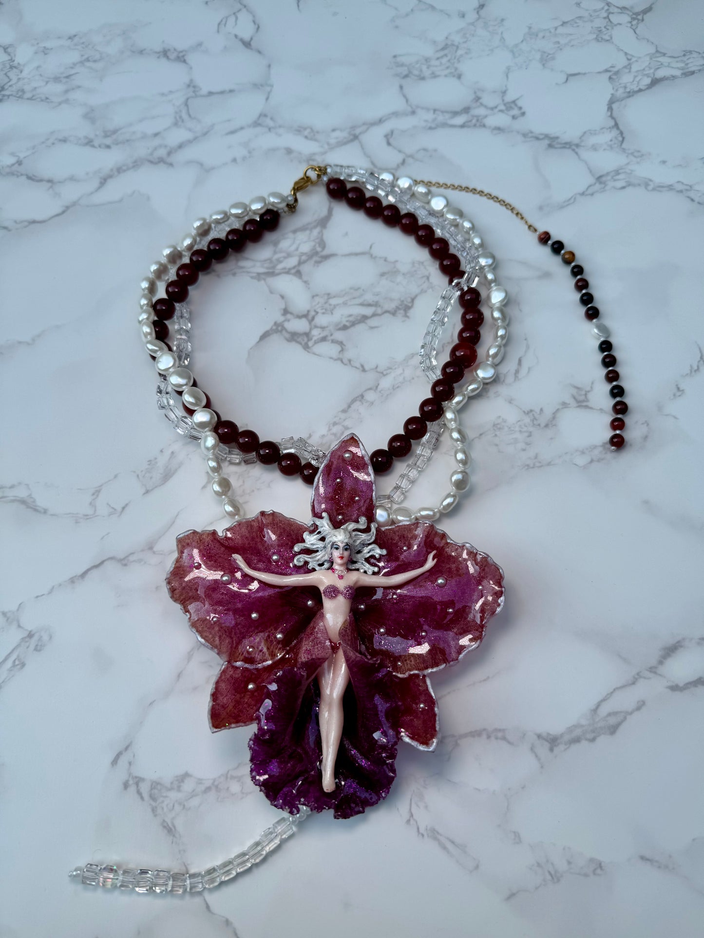 Calista – LIMITED EDITION – NYFW EXHIBITION PIECE Real Dark Purple Orchid with White Edges, Hand-Carved Female Figure, Mother-of-Pearl, Freshwater Pearls and Clear & Crimson Crystal Necklace