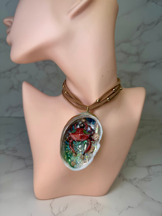 Crimson Cove Keeper Natural seashell featuring a miniature red-and-black dotted crab, multiple tiny seashells, and small glass balls encapsulated in clear UV resin