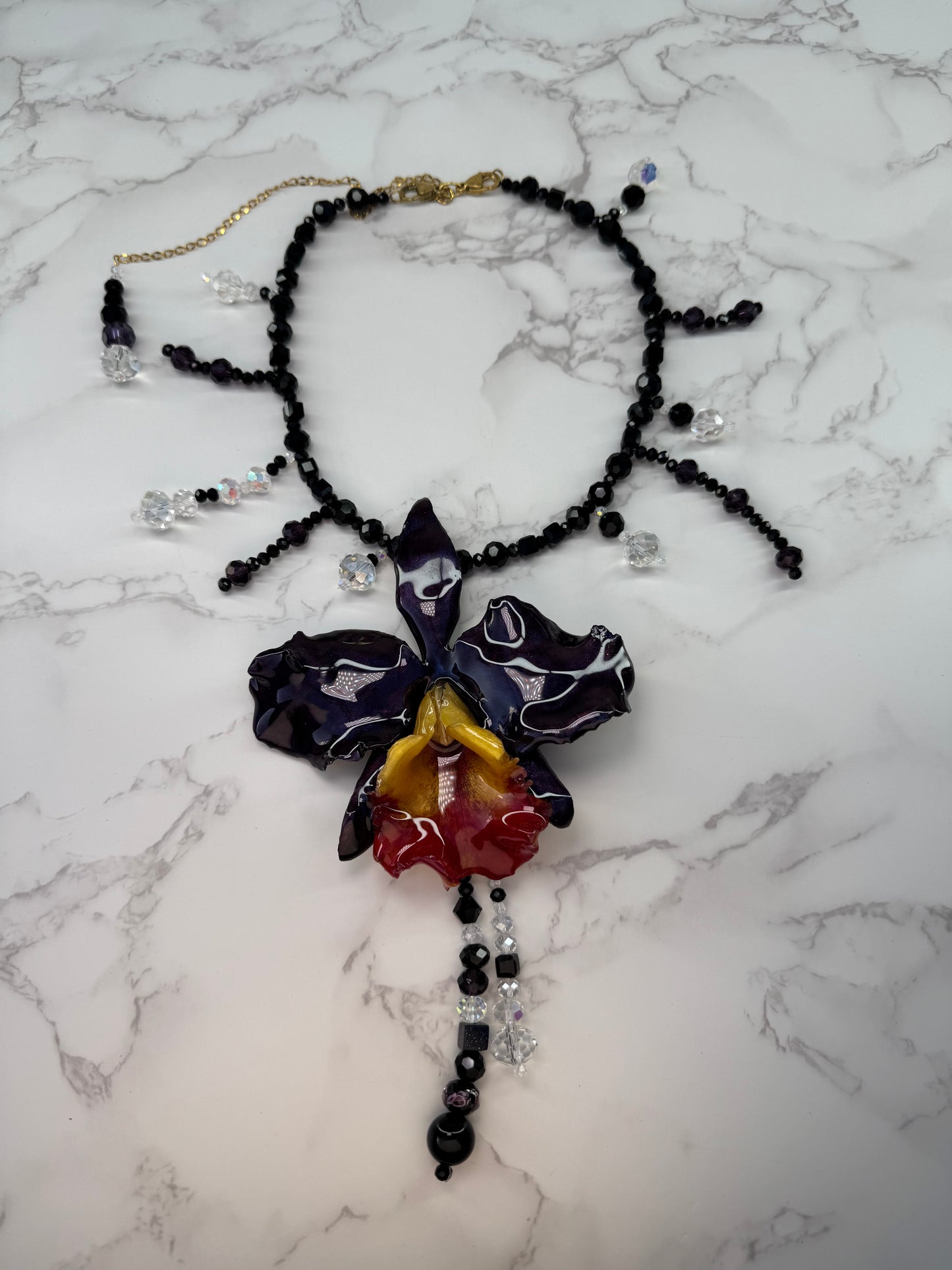 Midnight Cattleya Radiance Golden & Dark Purple Cattleya Orchid Necklace – Black Crystal Beads with Clear Crystal Accents