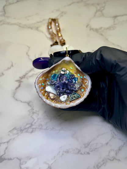 Violet Reef Whisper Natural seashell featuring a handmade metal purple octopus and colorful coral pieces encapsulated in clear UV resin Beautiful combined necklace