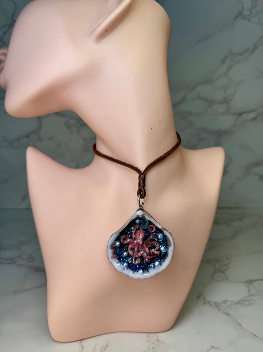 Crimson Pearl Drift Natural seashell featuring a beautiful handmade metal red octopus, blue sparkled rocks, and imitation pearls encapsulated in clear UV resin Leather necklace