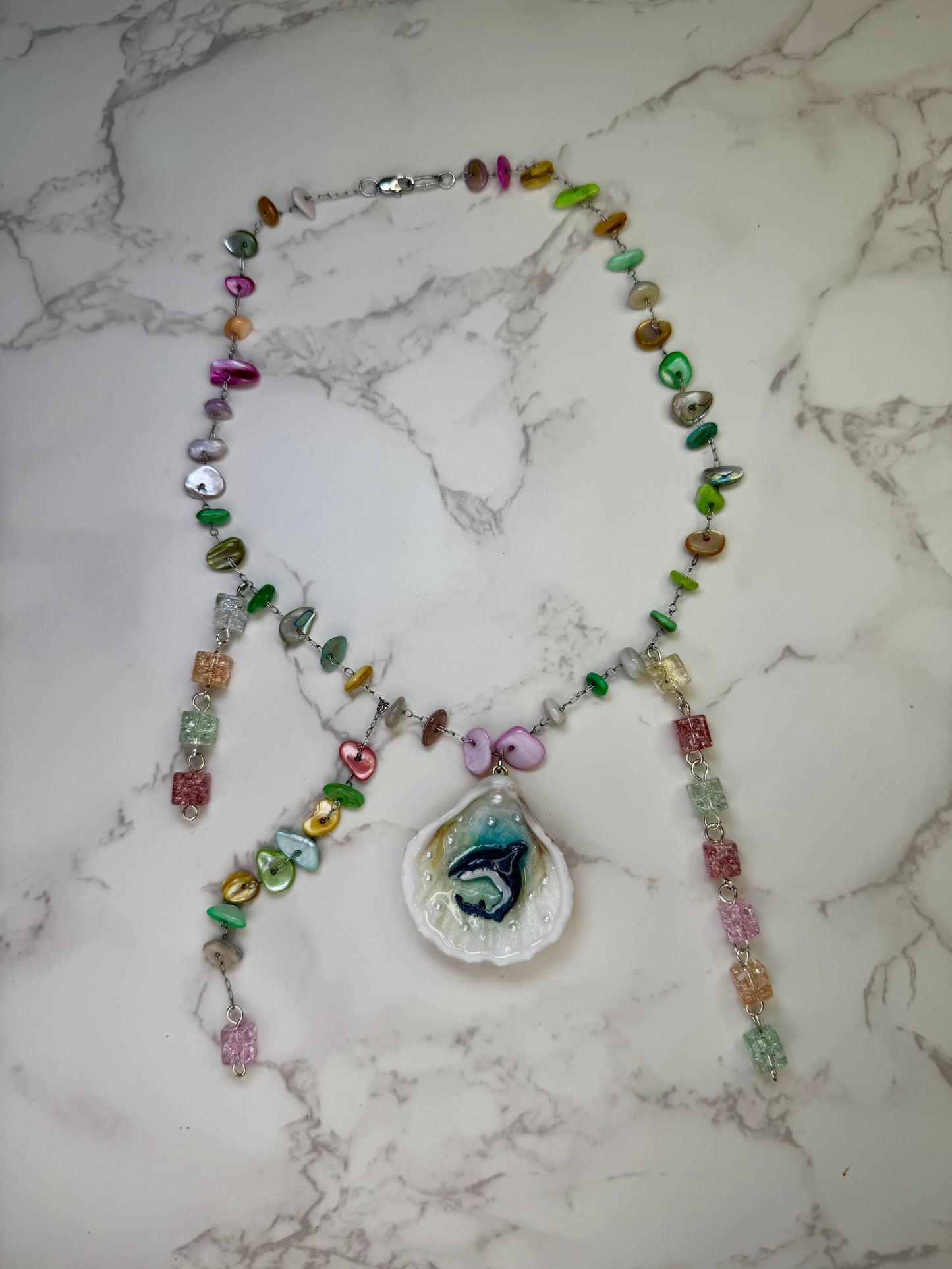 Rainbow Reef Hunter Tiny natural seashell featuring a miniature shark and multicolored glass rock beads (red, green, yellow, blue) encapsulated in clear UV resin stainless steel chain.