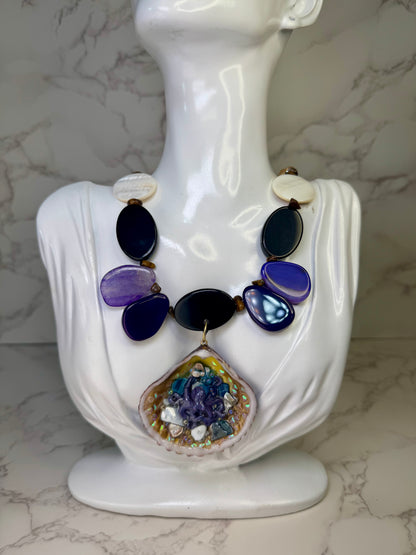 Violet Reef Whisper Natural seashell featuring a handmade metal purple octopus and colorful coral pieces encapsulated in clear UV resin Beautiful combined necklace