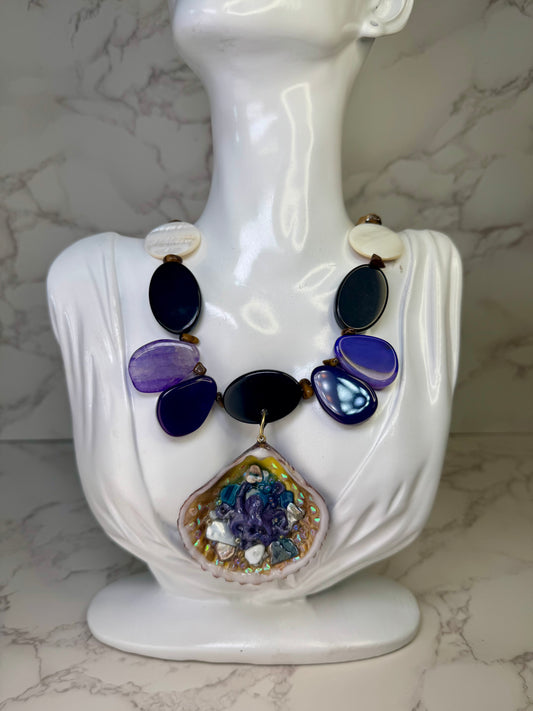 Violet Reef Whisper Natural seashell featuring a handmade metal purple octopus and colorful coral pieces encapsulated in clear UV resin Beautiful combined necklace