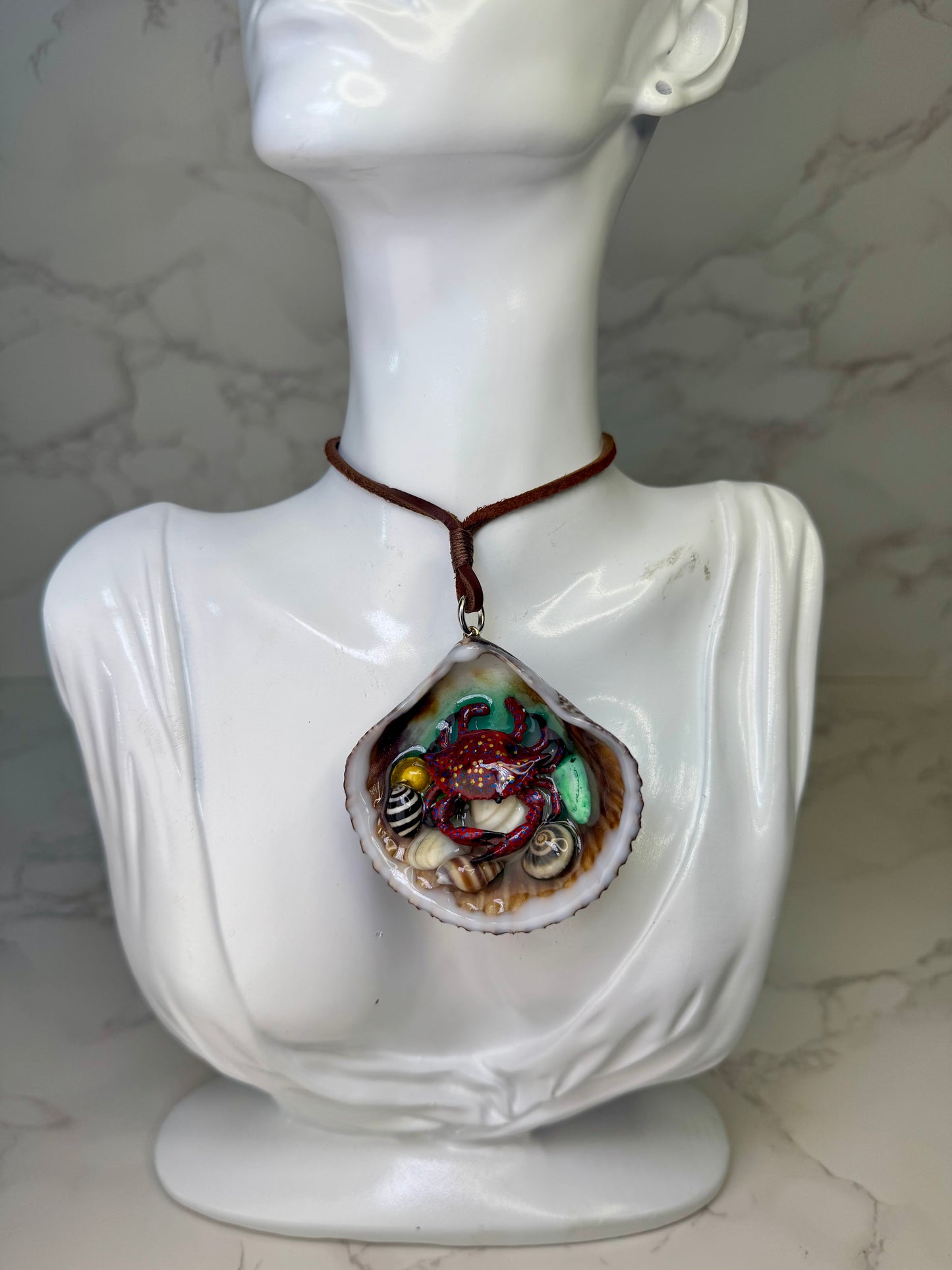 Sunburst Reef Guardian Natural seashell featuring a miniature handcrafted purple crab with orange and blue dots, surrounded by tiny blue rocks Fabric Cordon