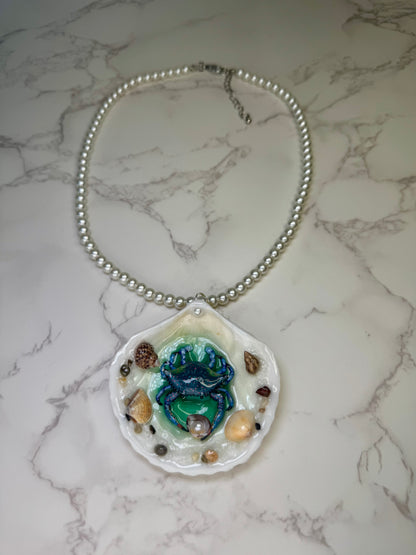 Tidal Blossom Crab Natural seashell featuring a handmade blue-and-pink dotted crab and small seashells encapsulated in clear UV resin Glasses Necklace