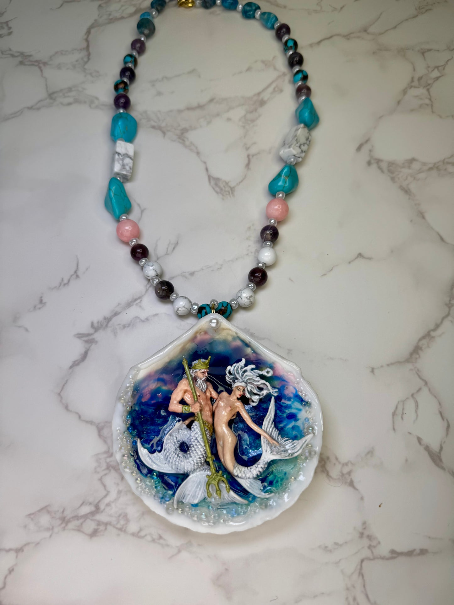 Mooncrest Royal Tides Natural seashell featuring a handmade craft mermaid king holding a mermaid queen, both with white hair and white shimmering tails preserved in UV resin Handmade crafts jewelry Beautiful Stones Necklace