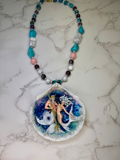 Mooncrest Royal Tides Natural seashell featuring a handmade craft mermaid king holding a mermaid queen, both with white hair and white shimmering tails preserved in UV resin Handmade crafts jewelry Beautiful Stones Necklace
