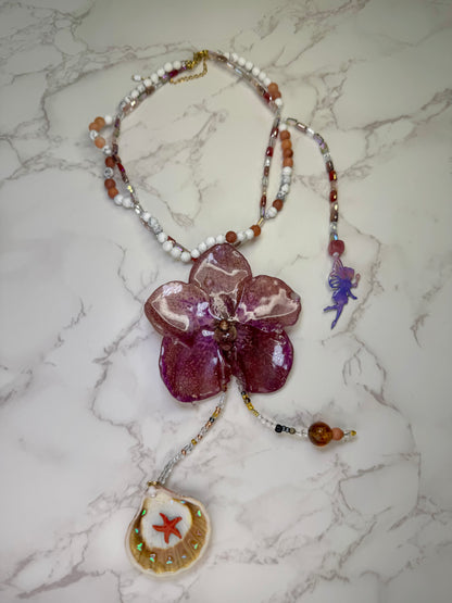Enchanted Orchid Wishes Natural Flower Preserved in Resin Real Purple-and-red banda orchid flower centerpiece Stones -Glasses Necklace with Tinkerbell Added in the necklace and Combined  with a Starfish in a Natural Shell