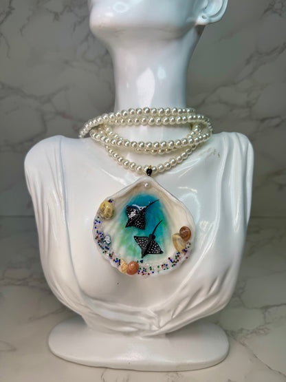Ocean Embrace Real seashell featuring two metal handmade craft miniature manta rays and tiny natural shells, encapsulated in clear UV resin. Beautiful extra long glass pearls necklace