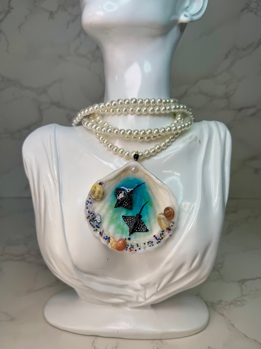 Ocean Embrace Real seashell featuring two metal handmade craft miniature manta rays and tiny natural shells, encapsulated in clear UV resin. Beautiful extra long glass pearls necklace