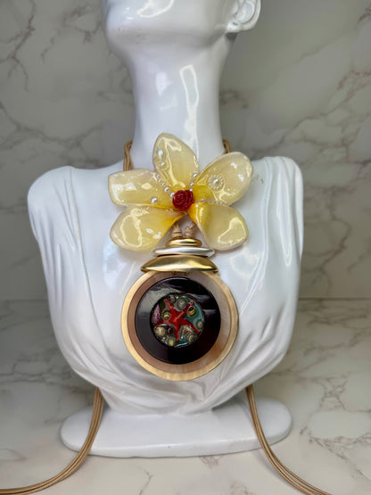 Sunlit Rose Tide Yellow flower with a miniature red rose center