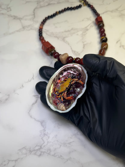 Amber Tide Spark Natural seashell featuring a miniature orange-and-black spotted crab and many tiny clear glass balls