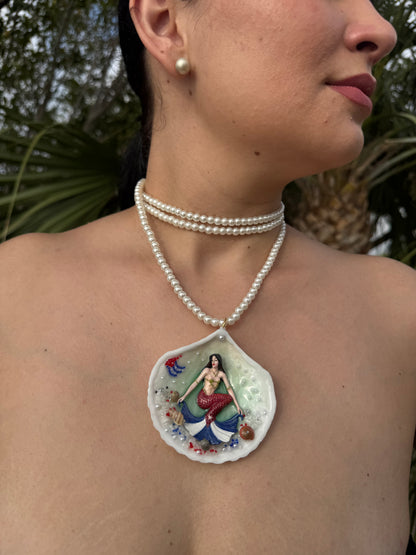 Cuba Libre Mermaid Natural seashell featuring a handmade craft metal mermaid with brown hair and a red tail inspired by the Cuban flag preserved in UV resin Beautiful Stones Necklace Handmade craft jewelry Crystal Pearl Necklace