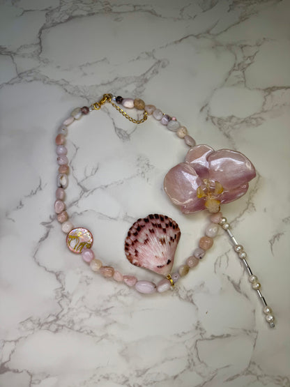 Pink Orchid Blossom Pink orchid flower centerpiece with a pink seashell holding a miniature sea turtle