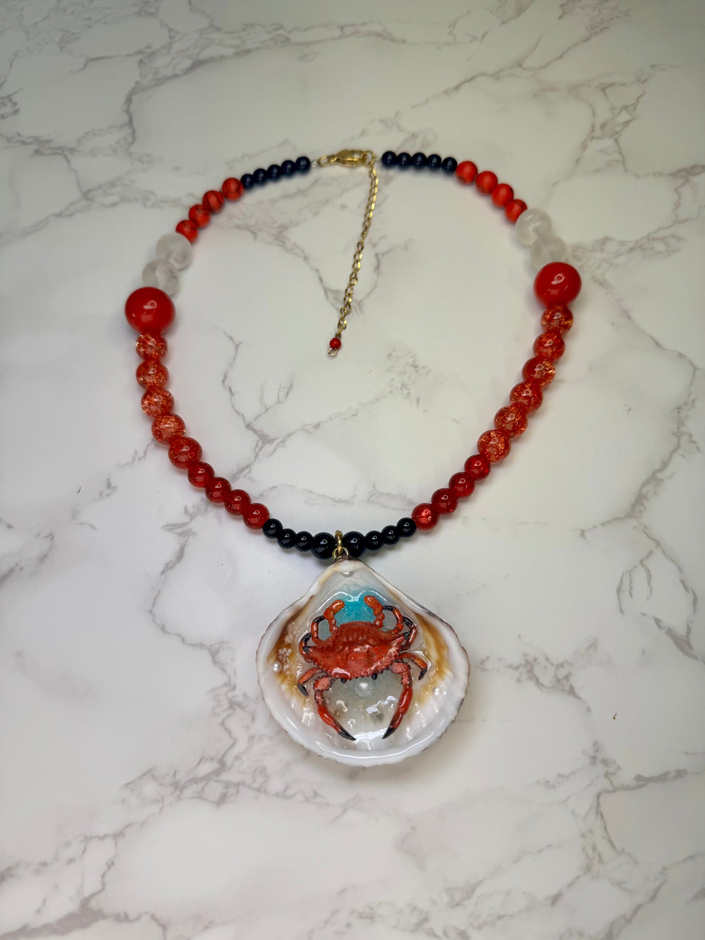 Fire Tide Sentinel Natural seashell featuring a handmade craft metal red-and-black spotted crab. Beautiful semiprecious Stones Necklace