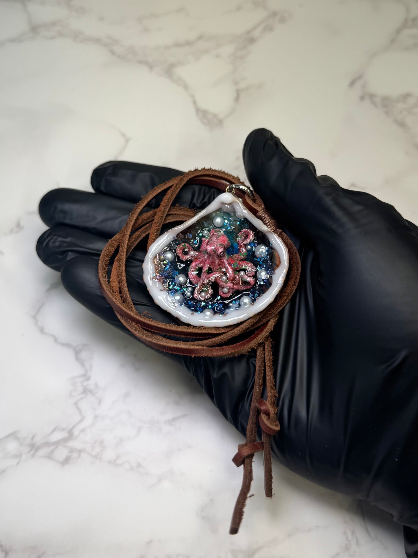 Crimson Pearl Drift Natural seashell featuring a beautiful handmade metal red octopus, blue sparkled rocks, and imitation pearls encapsulated in clear UV resin Leather necklace