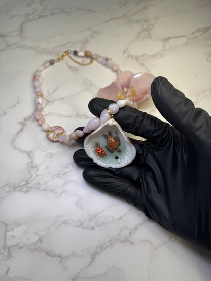 Pink Orchid Blossom Pink orchid flower centerpiece with a pink seashell holding a miniature sea turtle