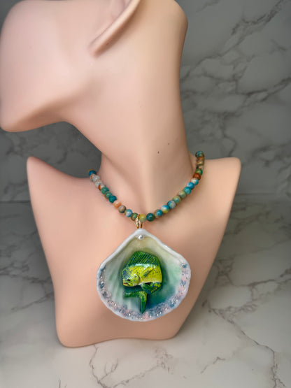 Tropical Horizon Drift Natural seashell featuring a beautiful unique metal handmade yellow-and-green mahi-mahi, glittered sand, and clear gems preserved in clear UV resin Beautiful natural stones necklace