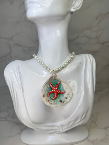 Coral Dawn Natural seashell featuring a red-and-white dotted starfish with sand and miniature coral rocks encapsulated in clear UV resin