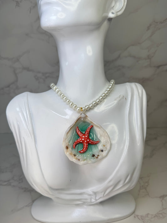 Coral Dawn Natural seashell featuring a red-and-white dotted starfish with sand and miniature coral rocks encapsulated in clear UV resin