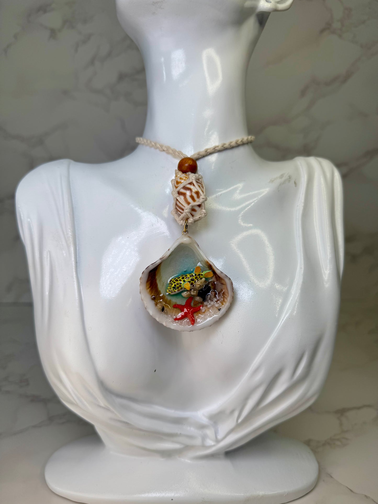 Sunny Shore Drift Natural seashell featuring a handmade metal yellow pufferfish with black spots, tiny red starfish, and delicate sand bits preserved in clear UV resin Beautiful corded necklace