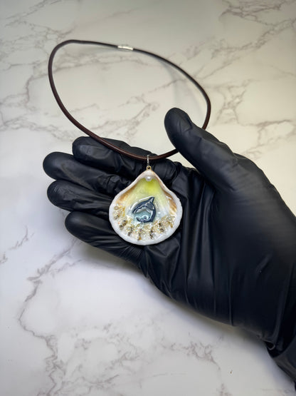 Mini Tide Hunter Tiny natural seashell featuring a handmade craft metal miniature shark and small crystals encapsulated in clear UV resin.  Leather necklace