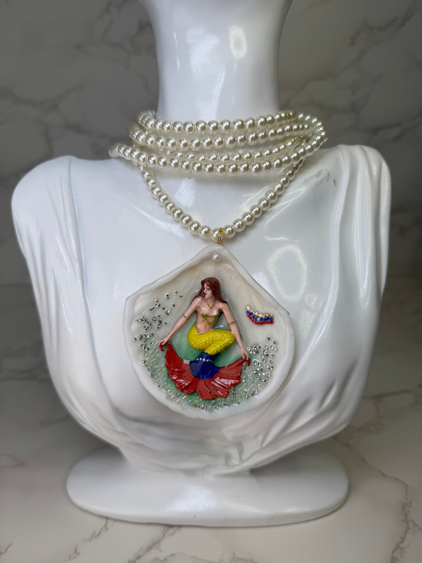 Venezuela Esperanza Siren Natural seashell featuring a miniature mermaid with brown hair and a yellow tail inspired by the Venezuelan flag
