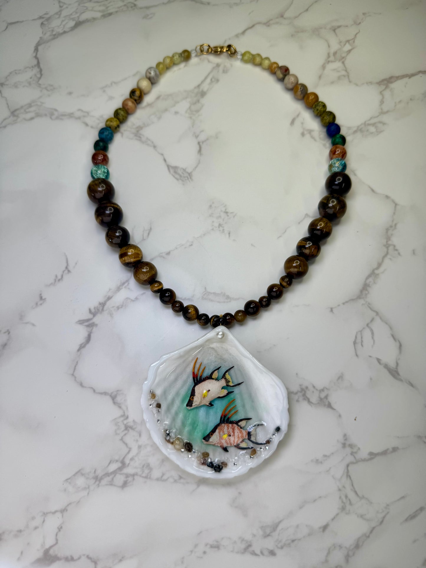 Twin Reef Drifters Natural seashell featuring two miniature hogfish and a brown crystal necklace encapsulated in clear UV resin