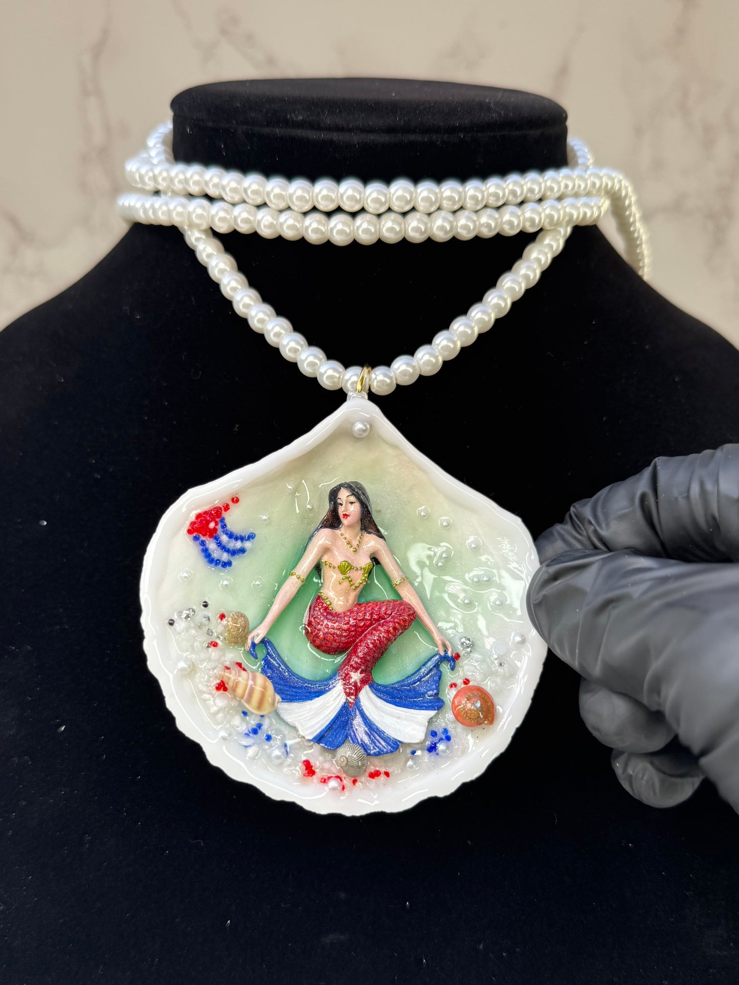 Cuba Libre Mermaid Natural seashell featuring a handmade craft metal mermaid with brown hair and a red tail inspired by the Cuban flag preserved in UV resin Beautiful Stones Necklace Handmade craft jewelry Crystal Pearl Necklace