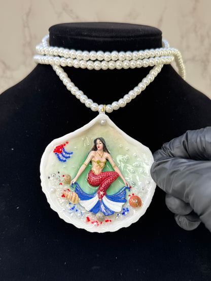 Cuba Libre Mermaid Natural seashell featuring a handmade craft metal mermaid with brown hair and a red tail inspired by the Cuban flag preserved in UV resin Beautiful Stones Necklace Handmade craft jewelry Crystal Pearl Necklace