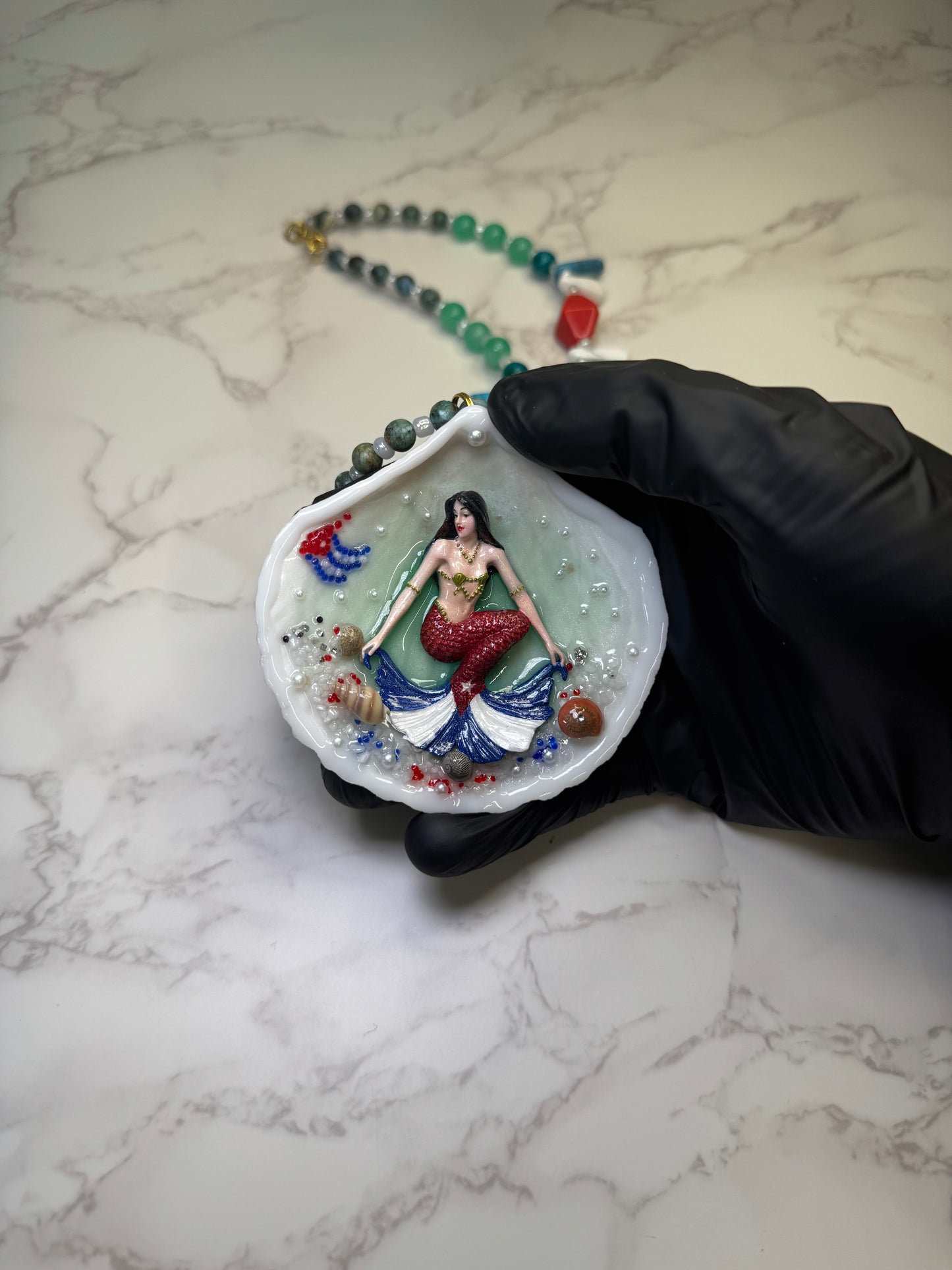 Cuba Libre Mermaid Natural seashell featuring a handmade craft metal mermaid with brown hair and a red tail inspired by the Cuban flag preserved in UV resin Beautiful Stones Necklace Handmade craft jewelry